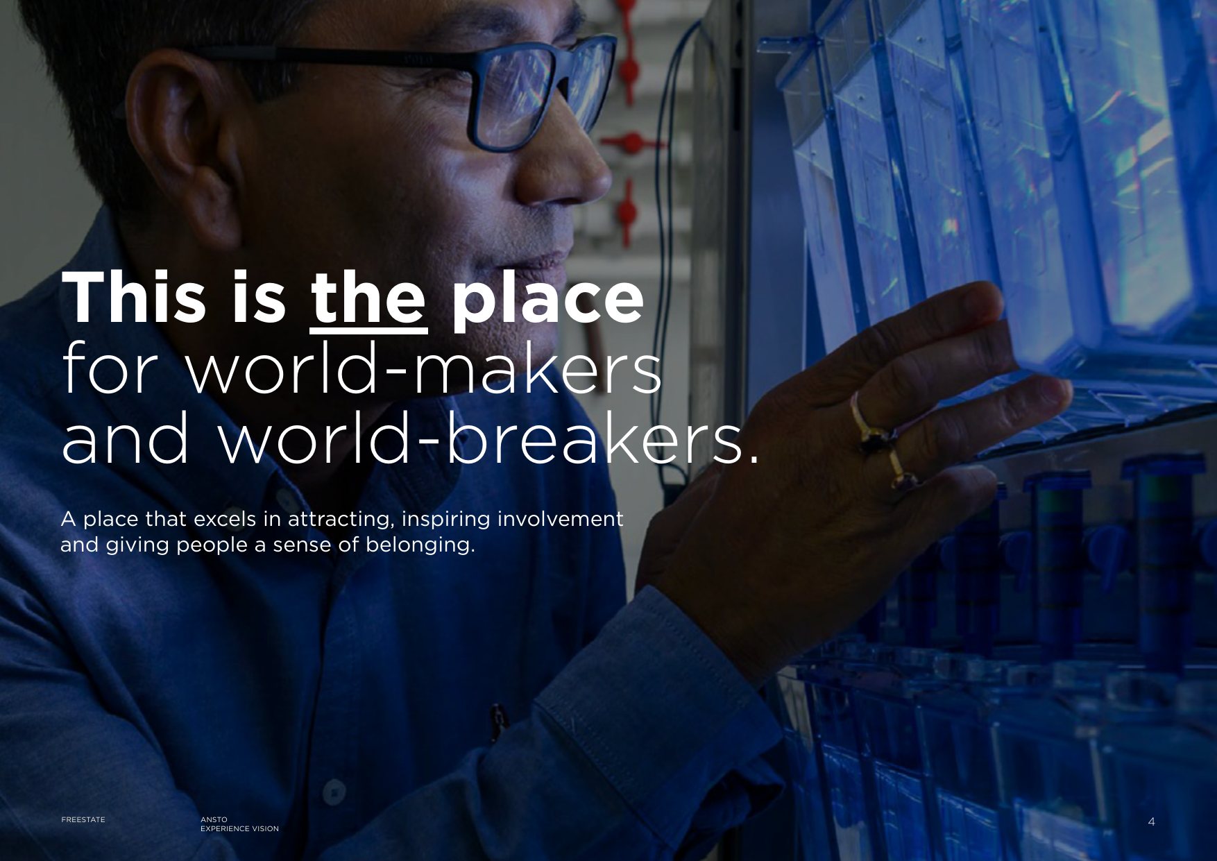 A scientist examining glowing blue laboratory equipment, with the line This is the place for world-makers and world-breakers.